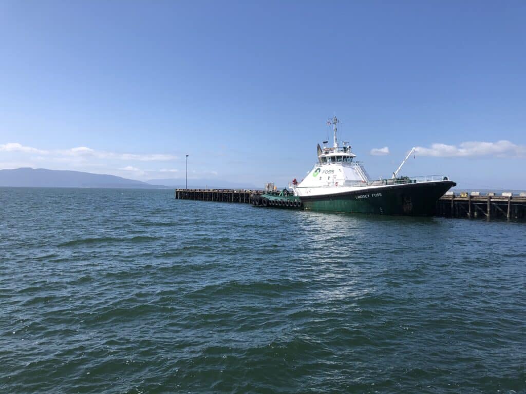 Ship docked at pier under clear sky.
