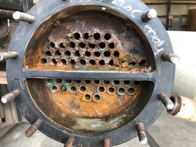 Corroded heat exchanger with visible rust damage.